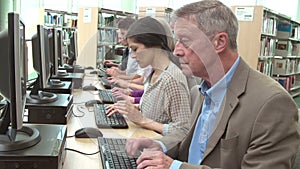 Group Of Mature Students Working At Computers