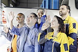 Group of mechanics men and woman raising hands