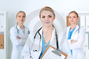 Group of medical doctors standing at hospital. Team of physicians ready to help patients. Medicine and health care