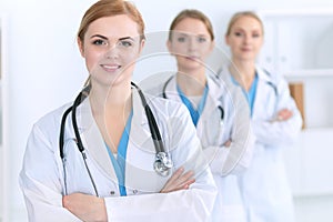 Group of medical doctors standing at hospital. Team of physicians ready to help patients. Medicine and health care