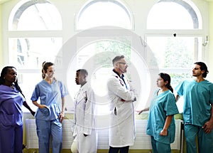 Group of medical professionals discussing in the hallway of a hospital photo