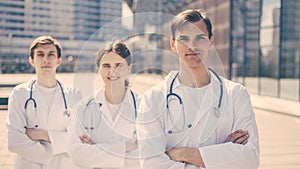 Group of medical professionals standing on a city street.