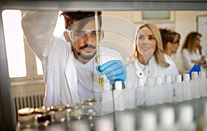 Group of medical research scientists collectively working in laboratory