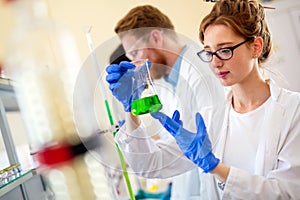 Group of medical research scientists collectively working in laboratory