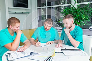 Group of medical staff discussing patient results in clinic. Healthcare professionals having discussion in hospital. Experienced