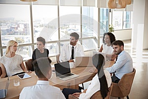 Group Of Medical Staff Meeting Around Table In Hospital photo