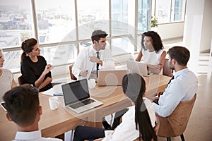 Group Of Medical Staff Meeting Around Table In Hospital photo