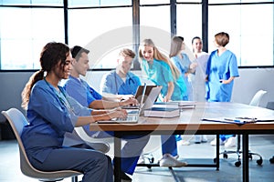 Group of medical students with gadgets in college