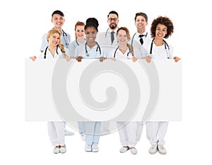 Group Of Medical Team Holding Blank Billboard