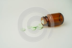 Group of medicine pills and antibiotics, White medical tablets, light green, in brown glass bottles, with copy space