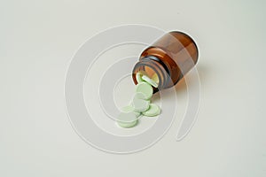 Group of medicine pills and antibiotics, White medical tablets, light green, in brown glass bottles, with copy space