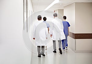 Group of medics or doctors walking along hospital