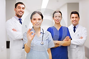 Group of medics at hospital showing ok hand sign