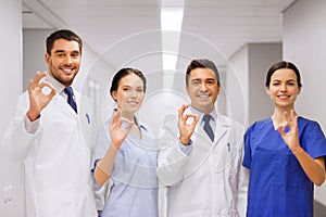 Group of medics at hospital showing ok hand sign