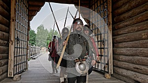 A group of medieval knights come back from the battle. Military campaign of knights