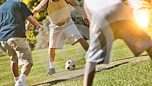 Group of Men Playing Soccer in park during lockdown with lens flare