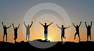 Group of men standing in a row on sunset background