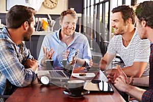 Group of men talking at a coffee shop