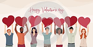 Group of men and women of different culture standing with arms raised holding a red heart.Valentine`s Day party concept.Copy space