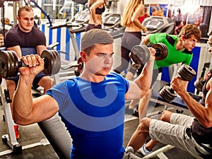 Group of men working his body at gym.