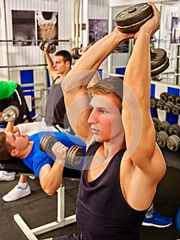 Group of men working his body at gym.