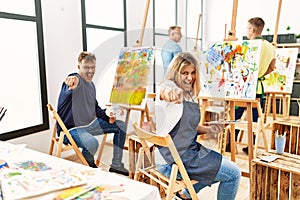 Group of middle age artist at art studio pointing displeased and frustrated to the camera, angry and furious with you