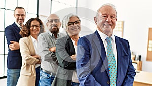 Group of middle age business workers smiling happy standing with arms crossed gesture at the office