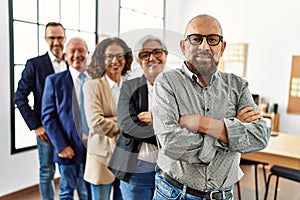 Group of middle age business workers smiling happy standing with arms crossed gesture at the office