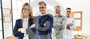 Group of middle age business workers smiling happy standing with arms crossed gesture at the office