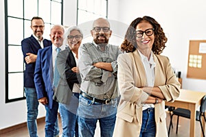 Group of middle age business workers smiling happy standing with arms crossed gesture at the office