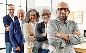 Group of middle age business workers smiling happy standing with arms crossed gesture at the office