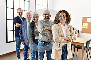 Group of middle age business workers smiling happy standing with arms crossed gesture at the office