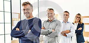 Group of middle age business workers smiling happy standing with arms crossed gesture at the office