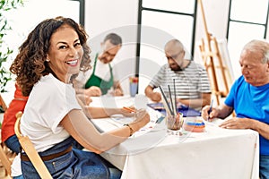 Group of middle age draw students sitting on the table drawing at art studio