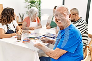 Group of middle age draw students sitting on the table drawing at art studio