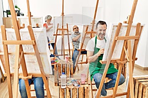 Group of middle age draw students smiling happy drawing at art studio