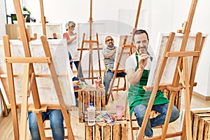 Group of middle age draw students smiling happy drawing at art studio