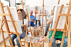 Group of middle age draw students smiling happy drawing at art studio