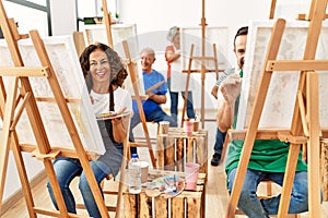 Group of middle age draw students smiling happy drawing at art studio