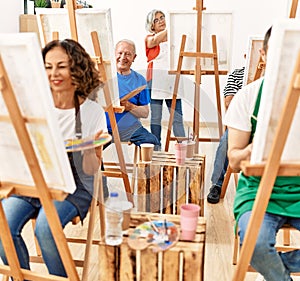 Group of middle age draw students smiling happy drawing at art studio