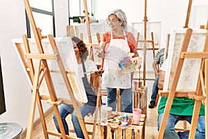 Group of middle age students drawing at art studio