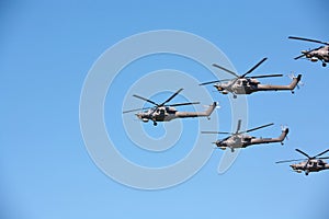 Group Military helicopters against the blue sky.