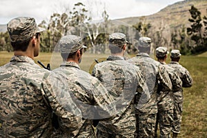 Group of military soldiers standing with rifles