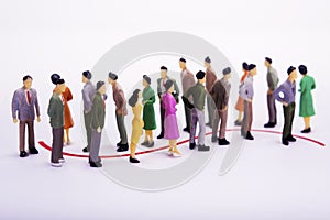 Group of miniature people over white background standing in line