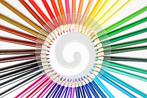 Group of mixed colourful pencils arranged in circle and isolated on white, children school or office suppliers photographed with s