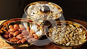 A group of mixed nuts in a golden bowl