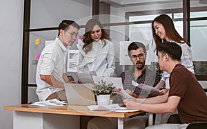 Group of mixed race creative or business people working, discussing, planing and working with happiness and joyfulness about their