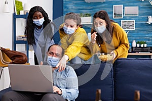 Group of mixed race friends having fun keeping social distancing