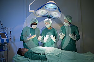 A Group of mixed-races professional surgeons operating in hospital operating room , health care concept