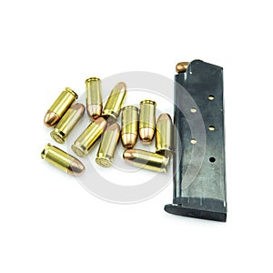 Group of 11mm bullets and magazine isolated